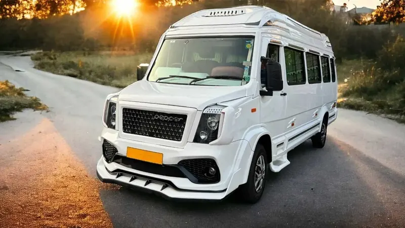 White tempo traveller on a road at sunset
